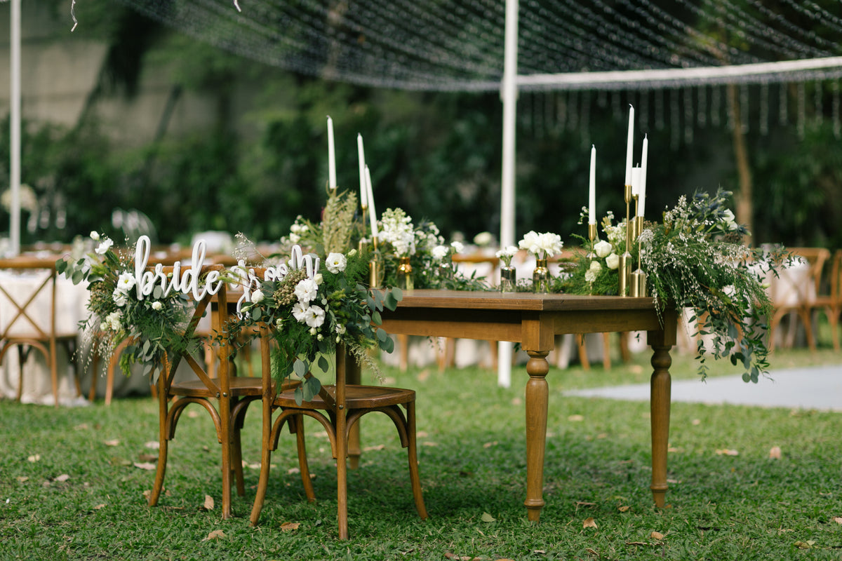 An intimate garden wedding table with candlelight and white flowers